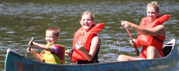 Women and two children canoeing
