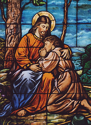 Jesus embraces a sinner in stained glass at St. John the Baptist in New Brighton. Photo by Father Michael Van Sloun