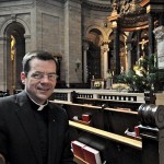 Father John Ubel sits in a pew at the Cathedral of St. Paul, where he will become rector of the Cathedral and pastor of the Cathedral parish on July 1. (Dianne Towalski / The Catholic Spirit)