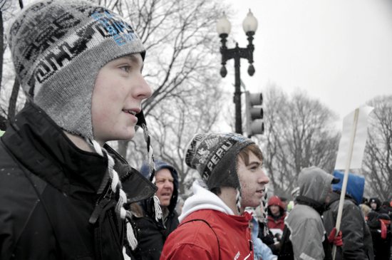 Caleb Burggraff and Joe Munsterteiger, parishioners of St. Henry in Monticello, march along Constitution Avenue. Maria Wiering / For the Catholic Spirit