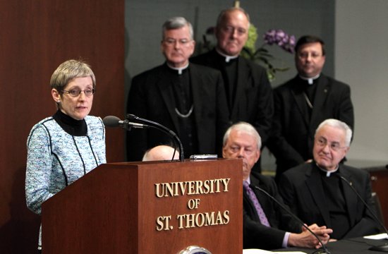 Julie Sullivan delivers remarks during a press conference Feb. 14 where she was announced as the next president of the University of St. Thomas in St. Paul. Listening to her comments are Archbishop John Nienstedt, top row, second from left; Father Kevin McDonough and Bishop Lee Piché. At bottom right is Father Dennis Dease, who will retire as president June 30. Sullivan currently serves as executive vice president and provost of the University of San Diego. She will be the first woman and first lay person to serve as president of UST. (Dave Hrbacek/The Catholic Spirit)