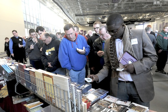 Terry Ndifuanja, right, from St. Peter in North St. Paul, peruses items for sale at the St. George Catholic Books table.