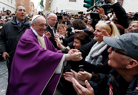 Pope Francis greets people after celebrating Mass at St. Anne's Parish within the Vatican March 17. The new pope greeted every person leaving the small church and then walked over to meet people waiting around St. Anne's Gate. (CNS photo/Paul Haring)