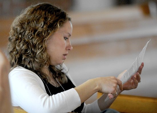 Above, Chrissy Klocker from St. Peter in North St. Paul participates in the Mass.