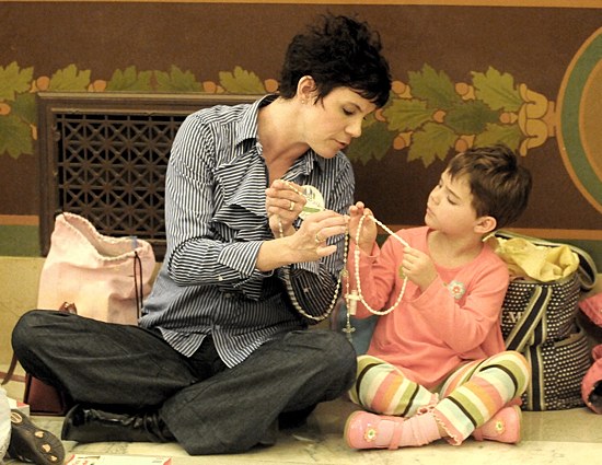 Angela Muttonen of St. Peter in Forest Lake prays the rosary at the State Capitol May 9 with her 5-year-old daughter Bridget. (Dianne Towalski / The Catholic Spirit)