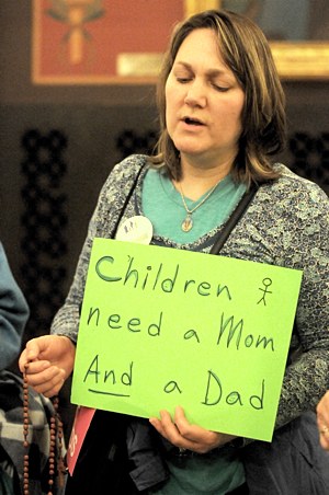 Barbara Herzog, a member of St. Peter in Forest Lake, prays the rosary with a large group gathered at the Minnesota State Capitol during a prayerful demonstration May 9 against a bill to change the definition of marriage. (Dianne Towalski / The Catholic Spirit)