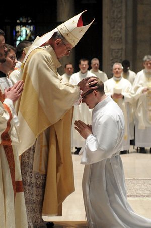 Archbishop Nienstedt ordains  Kevin Manthey with the laying on of hands. 