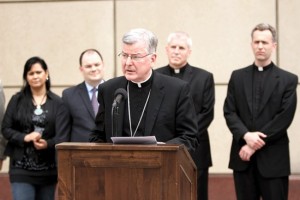 Archbishop John Nienstedt speaks at a press conference June 26 in Minneapolis announcing a joint statement from Minnesota faith leaders on federal immigration reform. Among those attending were, from left, the Rev. Yolandita Colon, executive justice pastor at Iglesia Maranatha Minneapolis; Jason Adkins, executive director of the Minnesota Catholic Conference; Father Kevin Kenney, pastor of Our Lady of Guadalupe in St. Paul; and Father Joseph Williams, pastor of St. Stephen in Minneapolis. (Dave Hrbacek / The Catholic Spirit)