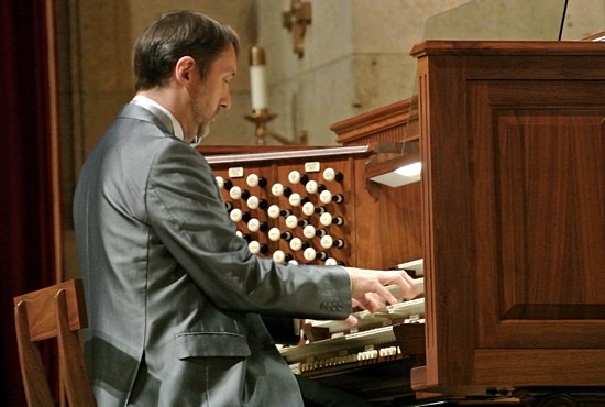 The Cathedral of St. Paul was filled to capacity with people standing in every available space for the inaugural concert of the Cathedral’s newly restored 1927 E.M. Skinner and 1963 Æolian-Skinner organs Oct. 24. Above, internationally acclaimed organist Olivier Latry of the Cathedral of Notre-Dame in Paris plays both historic pipe organs from the console that normally sits in the sanctuary behind the main altar. An identical console is located in the choir gallery. Both organs can be played from either console. Dianne Towalski/The Catholic Spirit