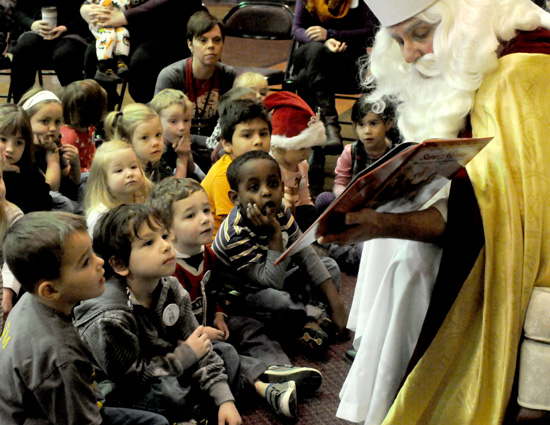 Children ages 2 to 6 were invited to spend a special St. Nicholas Fun Day  with preschoolers at the  school. Above, preschoolers, front row from left, Hank Hughes, Tomas Cortes, Jameson Johnston and Yonni Zelinskas listened intently to the story of St. Nicholas.