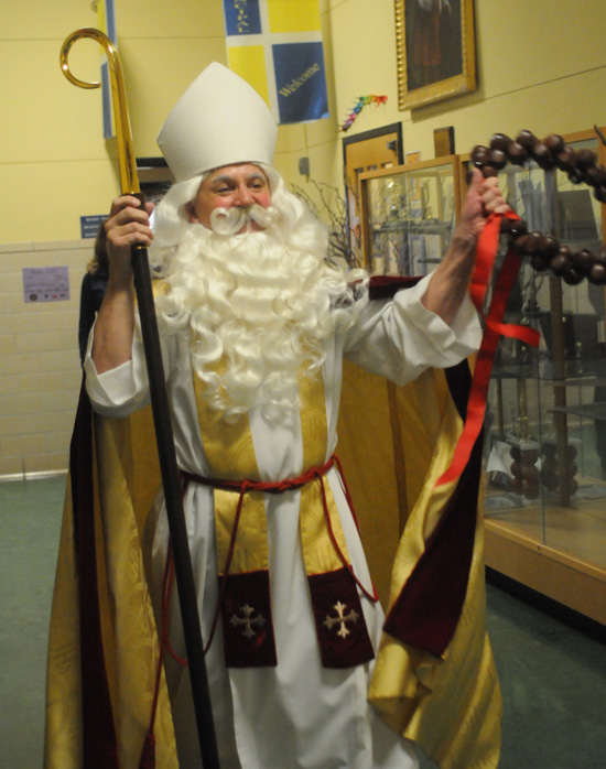 St. Nicholas walks down the hall at St. Thomas More School.