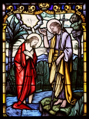 Christ’s baptism by John the Baptist at the Jordan River is depicted in a stained-glass window at St. Therese of Lisieux Church in Montauk, N.Y. CNS photo / Gregory A. Shemitz, Long Island Catholic