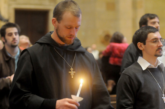 Franciscan Brother of Peace Max Connolly prays after the candlelit procession.
