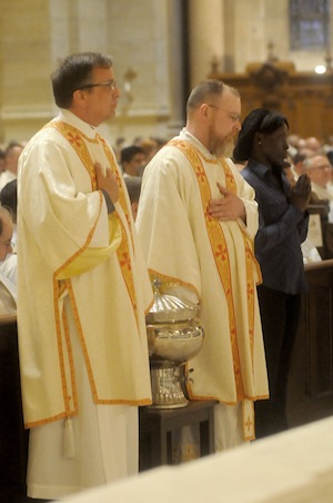 Deacon Larry Lawinger, left, and Deacon Michael Nevin waited before presenting the Sacred Chrism to Archbishop Nienstedt. Deacon Larry Lawinger, left, and Deacon Michael Nevin waited before presenting the Sacred Chrism to Archbishop Nienstedt. The Sacred Chrism is the primary annointing oil. It is used for baptism, confirmation and ordination. It is also used to anoint the altar and walls of new churches when they are dedicated. 