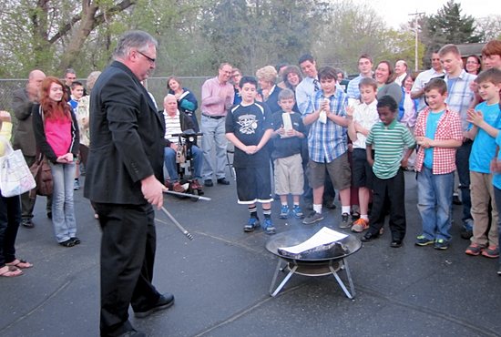 MORTGAGE BURNING Father Michael Miller, left, pastor of St. Michael in Stillwater, watches as the mortgage certificate burns during a special ceremony at the parish May 18, which also included Archbishop John Nienstedt. Under his leadership, the parish recently was able to retire a $8 million renovation debt. The project started in 2001 when Father Michael Skluzacek was the pastor. When Father Miller arrived in 2005, the remaining debt was $5 million for the project, which consisted of an atrium to the church, a three-level building containing a social hall, parish offices and meeting rooms, a middle school and a gymnasium. Photo by Jeanne Crea