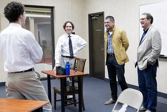 Chesterton Academy student Adrian Ahlquist (left) gets an impromptu Italian language lesson from Marco Sermarini (second from right), president of the Italian Chesterton Society and co-founder of the Chesterton School of Italy. Also pictured are Cameron Thompson (second from left), Chesterton Academy teacher, and Dale Ahlquist, president of the American Chesterton Society and co-founder of Chesterton Academy in Edina. Jennifer Janikula/For The Catholic Spirit