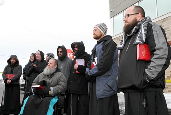 Third from left, Brother Paul O’Donnell, guardian of the the Franciscan Brothers of Peace, prays with members of his religious community at the Good Friday Prayer Service for Life in front of Planned Parenthood in St. Paul in this 2013 file photo. Brother Paul died Feb. 20. Dave Hrbacek/The Catholic Spirit