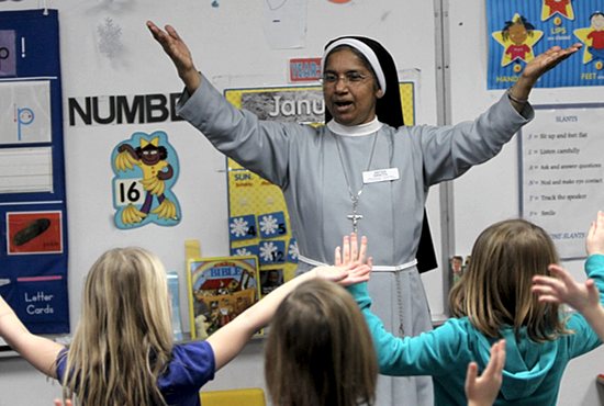 Franciscan Clarist Sister Sancta Ezhanikattu leads preschoolers in song at St. Therese School in Deephaven. She is one of four sisters in her order teaching at the school. Dave Hrbacek/The Catholic Spirit