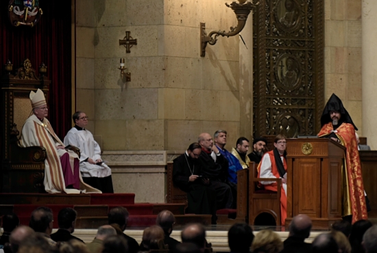 Father Aren Jebejian, pastor of St. Gregory the Illuminator Armenian Church in Chicago, speaks at the Cathedral of St. Paul during an ecumenical prayer service commemorating the 100th anniversary of the Armenian massacres April 18, as Archbishop John Nienstedt and Father Erich Rutten (far left) look on. Jim Bovin/For The Catholic Spirit
