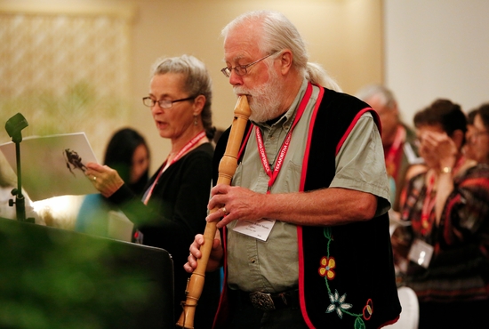 Lawrence Martin of the Gichitwaa Kateri Circle of Minneapolis plays a flute July 24, 2014, as he leads the Tekakwitha Conference in a song in the Ojibwe language at the organization’s annual meeting in Fargo, N.D. CNS