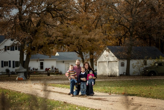 Aaron and Liz Rongen are pictured in front of their fifth generation homestead near Fertile, Minn. with their three children, John Douglas, Arthur and Mary Cate. Courtesy the Rongens