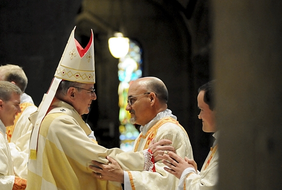 Archbishop John Nienstedt offers the greeting of peace to Deacon Vaughn Treco May 2 at the Basilica of St. Mary in Minneapolis. The Archbishop ordained Treco a deacon one day before the former Anglican priest became Father Treco, when ordained a Catholic priest by Bishop Andrew Cozzens at Holy Family Church in St. Louis Park. Photo by Dianne Towalski / For The Catholic Spirit