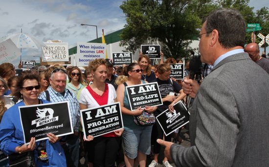 Brian Gibson, executive director of Pro-Life Action Ministries, speaks before pro-life advocates outside of Planned Parenthood in St. Paul July 28. Dave Hrbacek/The Catholic Spirit