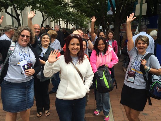 Pilgrims wave after arriving at the Pennsylvania Convention Center Sept. 22. From left, Emily Klinker, Beatriz Lopez, Leila Rodriguez, Maureen Portilla and Jean Stolpestad. Maria Wiering/The Catholic Spirit