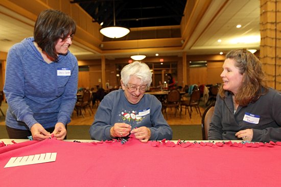 Chris Spinler, Dell Medcraft and Jean Bauer, all members of St. Elizabeth Ann Seton, talk as they work on a blanket. Dave Hrbacek/The Catholic Spirit