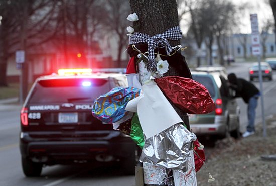 Balloons, flowers and signs mark the site where Jamar Clark was shot by a police officer Nov. 15 in north Minneapolis. Clark died the following day. Dave Hrbacek/The Catholic Spirit