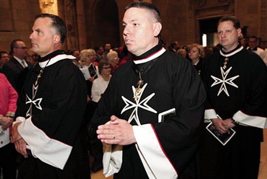From left, Order of Malta members John Dick of All Saints in Minneapolis, Matt Heffron of St. Columba in St. Paul and Ivan Postumous of the Cathedral of St. Paul take part in the processional during the priest ordination Mass May 30 at the Cathedral. Dave Hrbacek/The Catholic Spirit