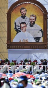 An image of Polish Conventual Franciscan Fathers Michal Tomaszek, top left, Zbigniew Strzalkowski and Italian Father Alessandro Dordi, are pictured during their beautification Mass at Chimbote stadium in Peru. The three priests were killed by insurgents in Peru in 1991. CNS 