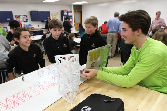 Totino-Grace High School senior John Wander, right, helps Frassati Catholic Academy seventh-graders Nicholas Gambeski, left, Jack Gorman and Conor Cooper with an engineering project during a visit Frassati students made to T-G to learn about the Engineering Institute. Dave Hrbacek/The Catholic Spirit