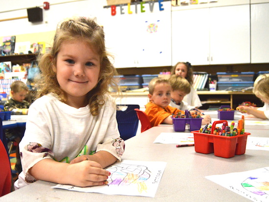 Preschooler Madilyn Terpstra looks up from her coloring work at St. Dominic School in Northfield. Bob Zyskowski/The Catholic Spirit