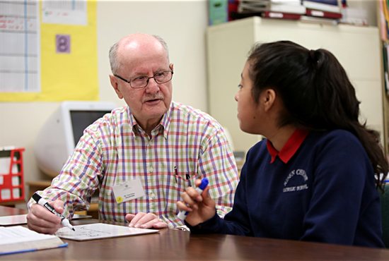 Ignatian Volunteer Corps Ignatian Volunteer Tom Foley works on math with eighth-grader Gissele Olivos Aguilar April 25 at Risen Christ Catholic School in Minneapolis. Dave Hrbacek/The Catholic Spirit