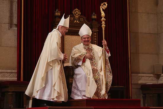 Archbishop Bernard Hebda sits on the cathedra for the first time, signifying his status as archbishop of St. Paul and Minneapolis May 13 at the Cathedral of St. Paul in St. Paul. With him is Archbishop Carlo Maria Vigano, papal nuncio to the United States. Dave Hrbacek/The Catholic Spirit