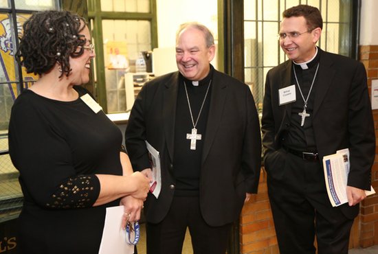 Archbishop Bernard Hebda and Bishop Andrew Cozzens visit with Dorwatha Woods, principal of Ascension Catholic School in Minneapolis during a tour April 22. Dave Hrbacek/The Catholic Spirit