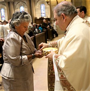 Archbishop Bernard Hebda gives Communion to his aunt and godmother, Yvonne Holland, at his installation Mass May 13 at the Cathedral of St. Paul in St. Paul. Dave Hrbacek/The Catholic Spirit