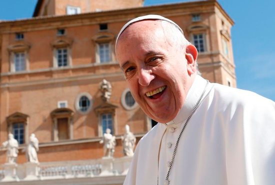 Pope Francis smiles as he arrives to lead his general audience in St. Peter's Square at the Vatican May 18. CNS photo/Paul Haring