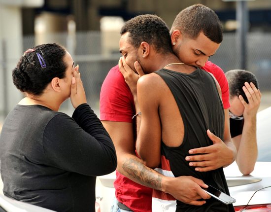 People embrace outside the headquarters of the Orlando, Fla., Police Department June 12 during the investigation of a mass shooting at a gay nightclub in Orlando. CNS/Steve Nesius, Reuters