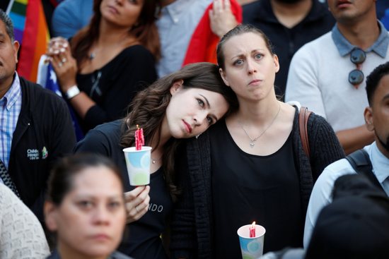 Women hold candles during a June 13 vigil in Los Angeles for the victims of the mass shooting at the Pulse gay nightclub in Orlando, Fla. A lone gunman, pledging allegiance to the Islamic State terrorist group, killed 49 people early June 12 at the nightclub. CNS/Lucy Nicholson, Reuters