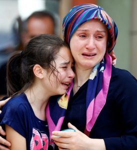 Relatives of one of the victims of the June 28 suicide attack at Istanbul's Ataturk Airport mourn June 29 in front of a morgue in Istanbul. The bombings killed dozens and wounded more than 200 as Turkish officials blamed the carnage at the international terminal on three suspected Islamic State group militants. CNS