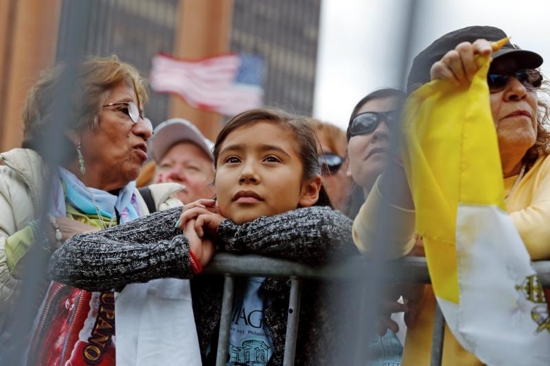 People watch on large screens as Pope Francis celebrates Mass in Philadelphia Sept. 26. World Youth Day organizers say the changing demographics of the church in the United States will be reflected in the pilgrims to World Youth Day in Krakow. CNS photo/Jonathan Ernst, Reuters)