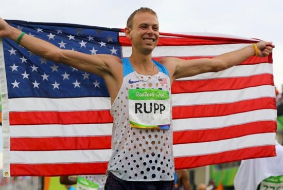 Marathon runner Galen Rupp poses with an American flag after finishing third in the 2016 Olympics in Rio de Janeiro Aug. 21. Rupp, a graduate of Central Catholic High School in Portland, Ore., became the first American-born athlete to medal in the marathon in 40 years. CNS photo/Lucy Nicholson, Reuters