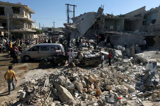 People gather July 25 at a site hit by airstrikes in a rebel-held neighborhood in Aleppo, Syria. CNS photo/Ammar Abdullah, Reuters