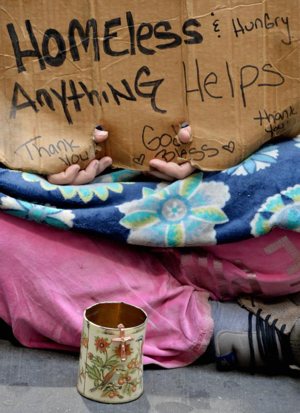 A homeless woman sits on a sidewalk in 2014 in New York City. Despite there being 46.7 million Americans living in poverty, there has been little talk about the needs of poor people on the presidential campaign trail. CNS photo/Justin lane, EPA