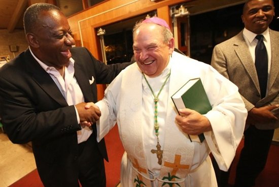 Prayer service for peace cutline: Archbishop Bernard Hebda greets Tyrone Terrill of St. Paul, left, after the Vigil Prayer for the Day of Prayer for Unity and Peace Sept. 8 at St. Peter Claver in St. Paul. At right is Willie Green of St. Peter Claver. Archbishop Hebda, who delivered the homily, joined Bishop Andrew Cozzens, Father Erich Rutten, pastor of St. Peter Claver, and Deacon Fred Johnson of St. Peter Claver. Also attending was Rev. Charles Gill, pastor of Pilgrim Baptist Church in St. Paul, who delivered remarks during the prayer service. Dave Hrbacek/The Catholic Spirit