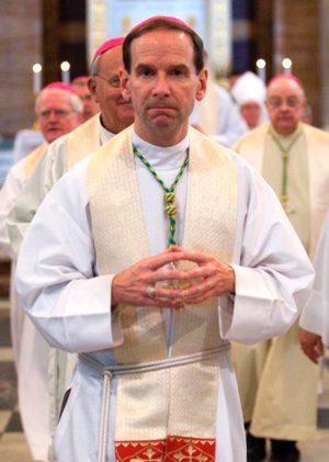 Bishop Michael Burbidge of Raleigh, N.C., processes with other U.S. bishops after concelebrating Mass in 2012 at the Vatican. Pope Francis accepted the resignation of Bishop Paul Loverde of Arlington, Virginia, and named Bishop Burbidge as his successor. CNS photo/Alessia Giuliani, Catholic Press Photo