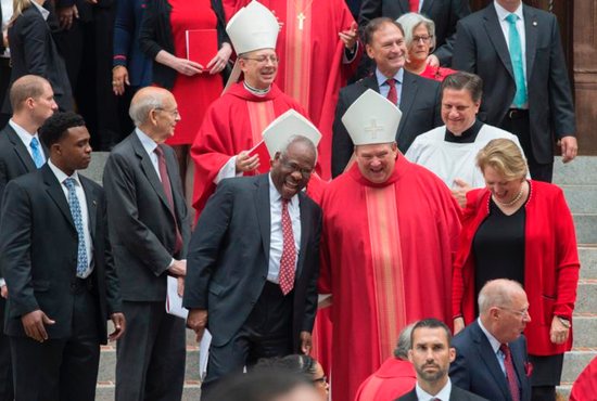 Archbishop Bernard Hebda of St. Paul and Minneapolis and U.S. Supreme Court Justice Clarence Thomas share a light moment as they leave the Cathedral of St. Matthew the Apostle in Washington after the annual Red Mass Oct. 2. Also pictured above are Auxiliary Bishop Barry Knestout of Washington and U.S. Supreme Court Justice Samuel Alito. CNS photo/Jaclyn Lippelmann, Catholic Standard