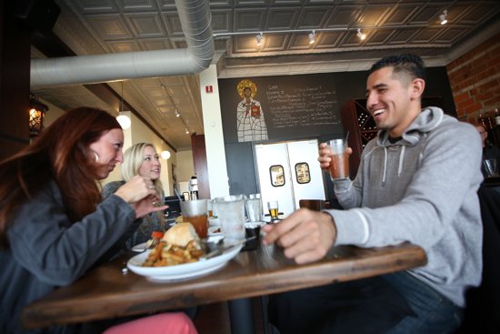 From left, Sarah Robinson, Andria Kroona and Alex Sanchez eat lunch at Augustine’s Bar and Bakery in St. Paul Nov. 15. Dave Hrbacek/The Catholic Spirit 